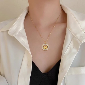 Minimalist gold titanium steel butterfly necklace with gemstone ring pendant on model