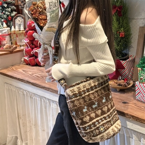 Detail of plush crossbody bag with bohemian geometric pattern for winter style