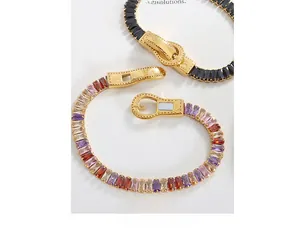 Macro view of gold plated bracelets featuring square cut colorful zircons and magnetic buckle
