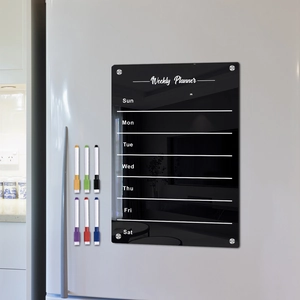Macro view of magnetic acrylic weekly planner with six colorful markers on a white fridge
