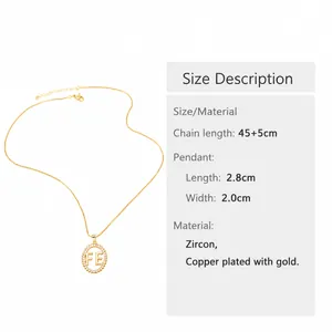 Detailed close-up of FE letter cross pendant with sparkling zircons and gold-plated chain
