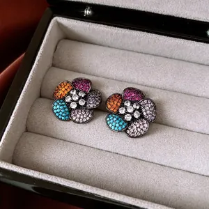 Vintage style floral stud earrings with multi-colored crystals in a black jewelry box