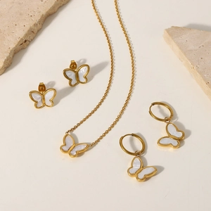 Detailed set of 18K gold butterfly necklace and earrings with white shell inlays