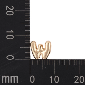 Close-up of golden letter W pendant charm on metric scale ruler showing 10mm size