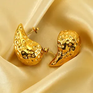 Polished 18K gold-plated teardrop earrings with hammered texture on golden silk