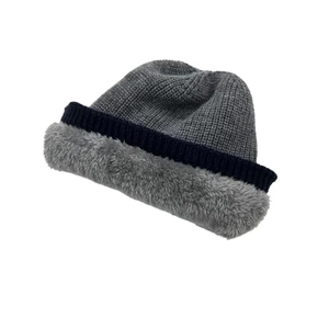 Detail of winter knit hat with three-color stitching and soft gray faux fur lining