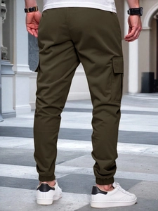 Men's olive green cargo joggers featuring elastic cuffs and utility pockets back view