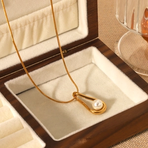 Elegant gold-plated stainless steel necklace with teardrop pearl pendant in a wooden box