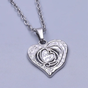 Macro detail of the multilayer hollow heart pendant in polished silver stainless steel