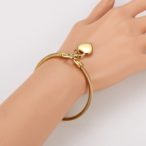 Elegant gold twisted cable cuff bracelet with heart pendant charm for women
