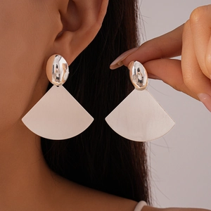 Silver geometric fan-shaped earrings with brushed metal finish on model