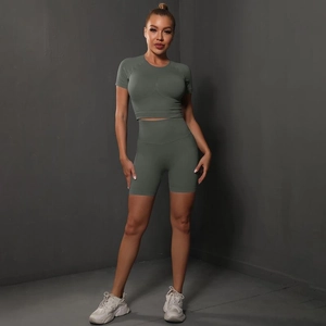 Detail of olive green seamless yoga set featuring a cropped top and peach lift shorts