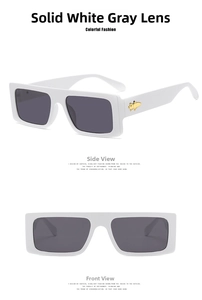 Makro-Detail der weißen quadratischen Sonnenbrille mit goldenen Katzen-Metallakzenten