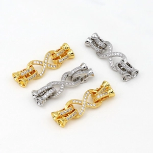 Macro detail of 18K gold and silver plated infinity clasps with sparkling cubic zirconia