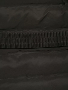 Detail of waterproof black fabric with reinforced stitching and elastic hem design