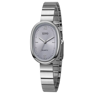 Macro detail of oval silver quartz watch with bamboo-style steel link bracelet and dial