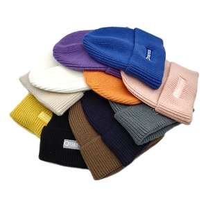 Colorful ribbed knit beanie hats for men and women featuring a stylish brand label