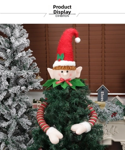 Detailed view of plush Christmas elf tree topper with red hat and striped knit sleeves