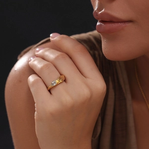 Detail of 18k gold plated snake ring featuring a pear-cut zircon and scale texture