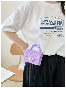 Detail of purple jelly crossbody bag with beaded handle and golden chain strap