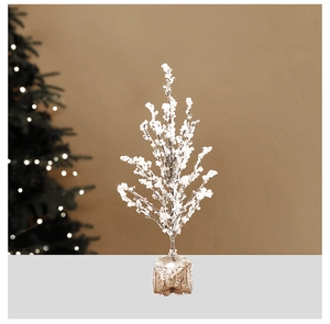 Detail of white frosted mini Christmas tree with snow texture and natural wood base