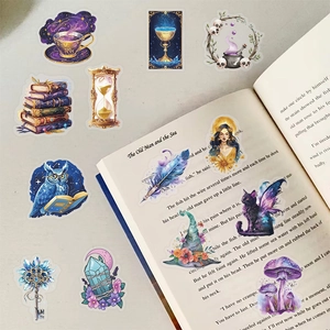 Close-up of magic planet stickers scattered on an open book for aesthetic journaling