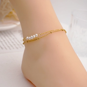 Double-layered gold titanium steel anklet featuring five freshwater pearls and beads