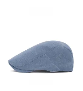 Side profile of a greyish-blue corduroy beret hat with detailed knitting texture