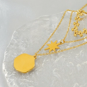 Three-layer gold stainless steel necklace with octagonal star and round disc pendants