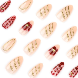 3D almond press-on nails with red floral patterns and gold wave textures on white background