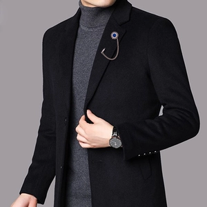Blue gemstone lapel pin with golden chain on black suit jacket for men and women