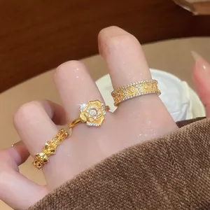 24K gold plated flower and bow ring set with zircon stones on female hand