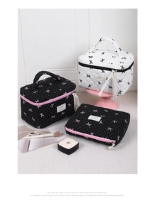 Close-up of quilted makeup bag with bow patterns and durable double zipper detailing