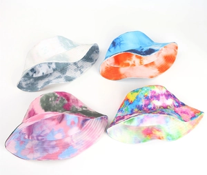 Flat lay of tie-dye bucket hats in grey, blue-orange, pink, and neon color palettes