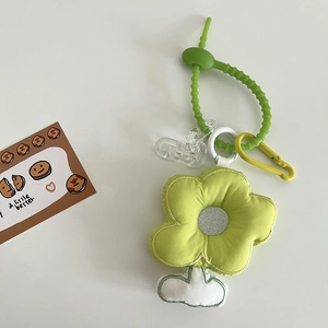 Detail of plush flower charm with green embroidery, elastic cord and acrylic chain
