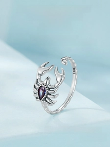 Detailed view of vintage S925 silver scorpion ring with a purple pear-cut gemstone