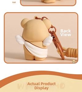 Back view of a khaki cartoon bear keychain with white angel wings and metal hook