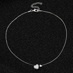 Silver double heart pendant necklace with rhinestones on a sparkling black background