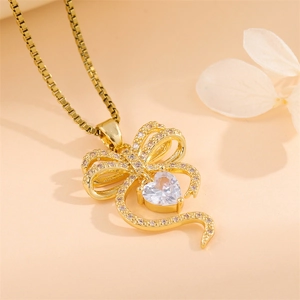Elegant gold bow heart pendant necklace with shimmering white center stone for women