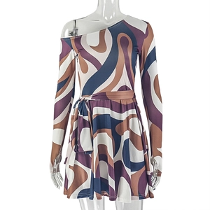 Detail view of abstract swirl pattern in brown and purple on off-shoulder A-line dress