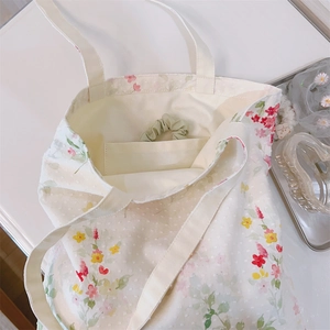 Macro shot of cotton floral tote bag texture with inner pocket and jacquard details