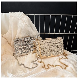 Detailed macro view of gold and silver evening clutch bags with liquid metal texture