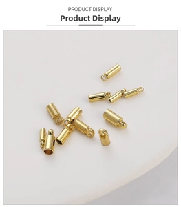 Detailed view of polished 14k gold-plated cylinder connectors for DIY jewelry making