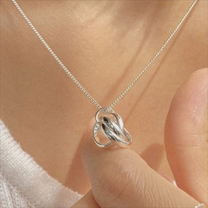 Close-up of S925 sterling silver interlocking triple ring pendant on a delicate chain
