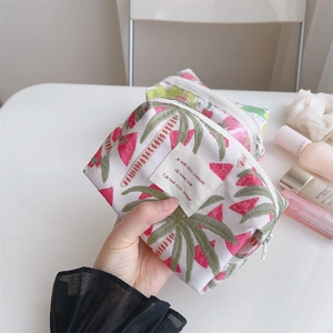 Close-up of small floral jacquard boat bag with pink tropical leaves and watermelon print