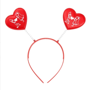 Detail of red spring headband featuring satin heart with romantic couple illustration