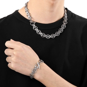 Men's silver Byzantine chain necklace and bracelet set with T-bar clasp worn on black shirt