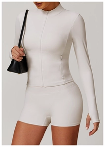 Detail of slim fit long sleeve sports jacket with thumb holes and matching high waist shorts