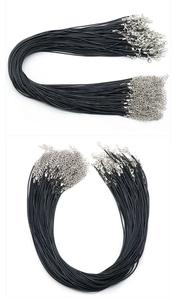 Close-up of black waxed necklace cords with silver lobster clasps and extension chains