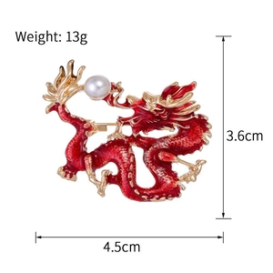 Detail view of red enamel dragon brooch with size specs and a white pearl accent